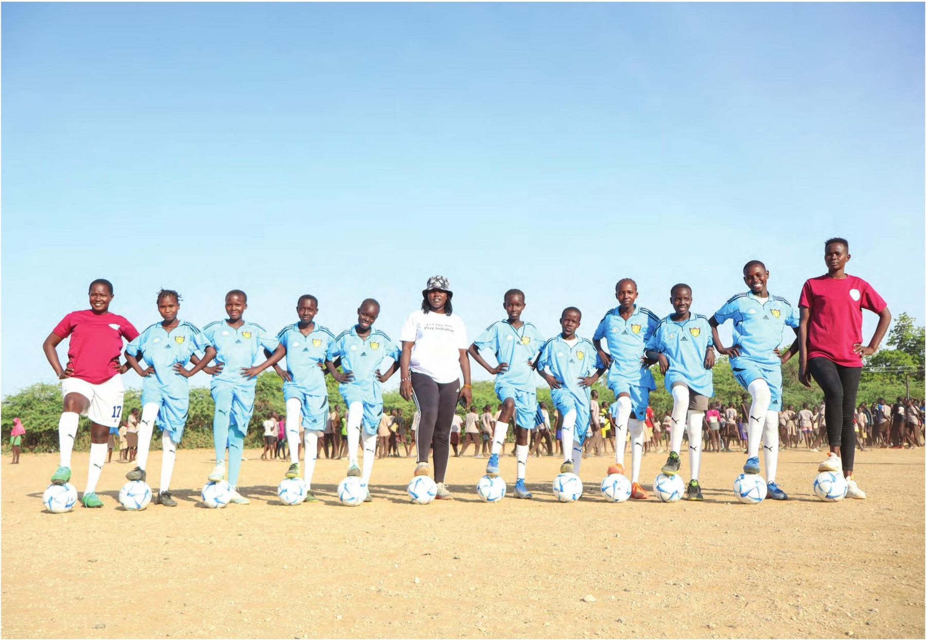 Desert Roses team lined up with footballs in Turkana