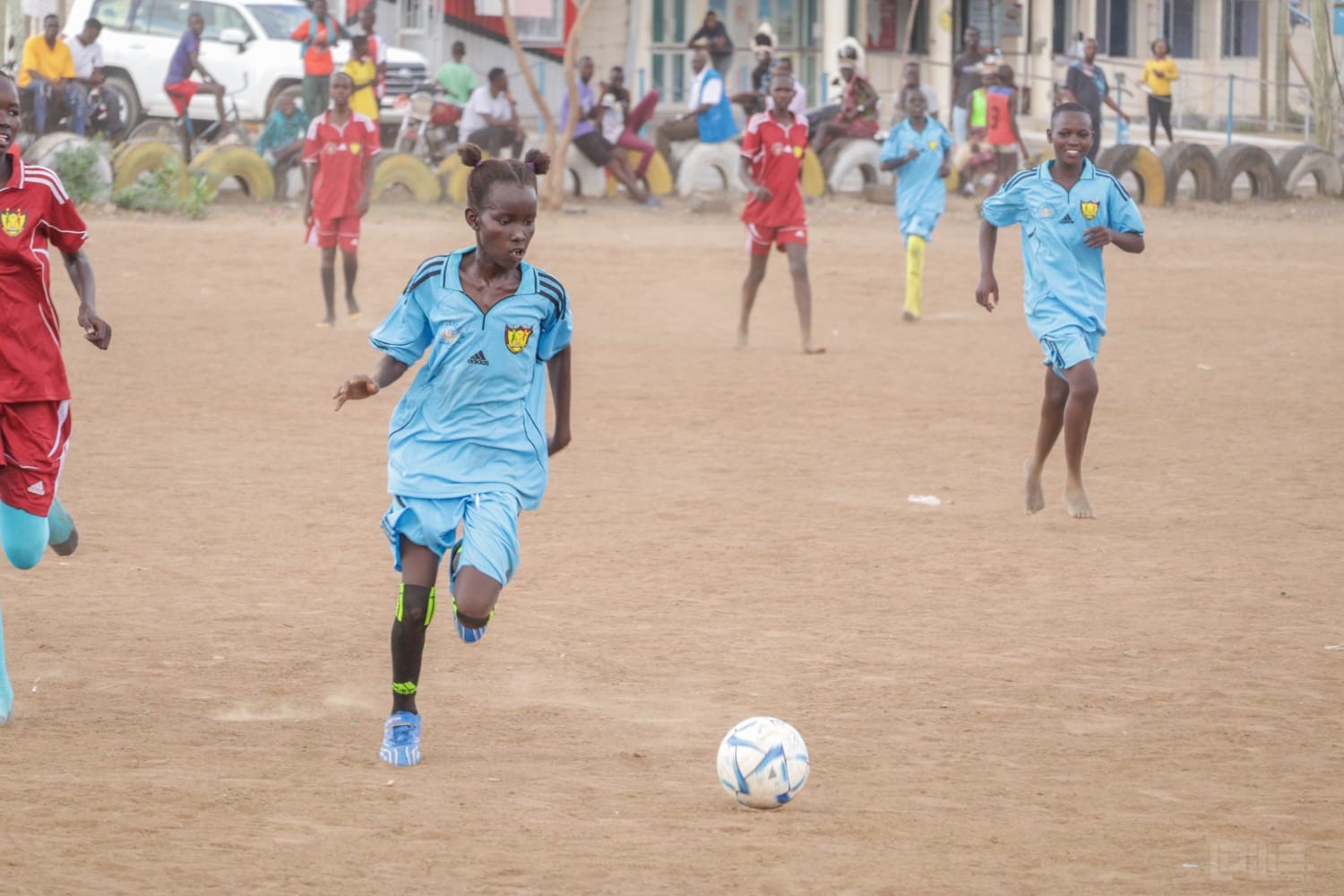 A Desert Roses player running with the ball during a match in Turkana